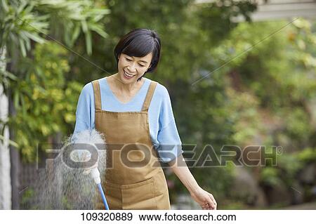 Senior Japanese woman gardening View Large Photo Image Stock Photo - Senior Japanese woman gardening. Fotosearch