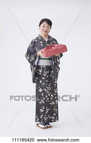 Stock Image - Senior Japanese woman wearing kimono. Fotosearch
