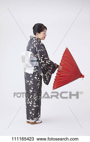 Stock Image - Senior Japanese woman wearing kimono. Fotosearch