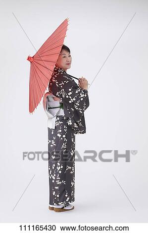 Stock Image - Senior Japanese woman wearing kimono. Fotosearch