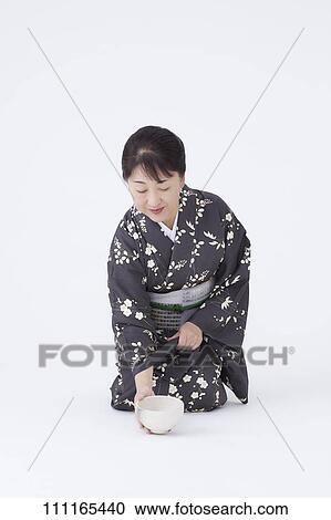 Stock Image - Senior Japanese woman wearing kimono. Fotosearch