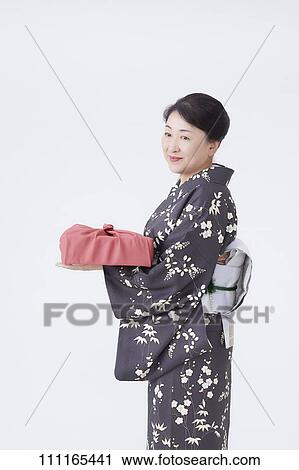 Stock Image - Senior Japanese woman wearing kimono. Fotosearch
