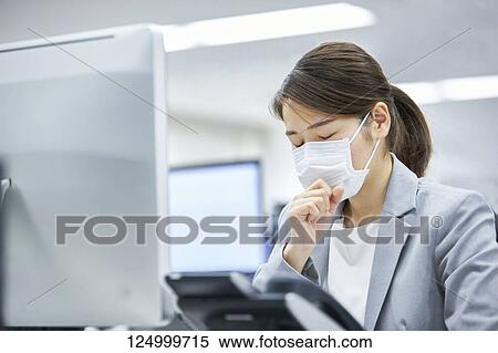 Sick Japanese businesswoman in the office View Large Photo Image Stock Photography - Sick Japanese businesswoman in the office. Fotosearch