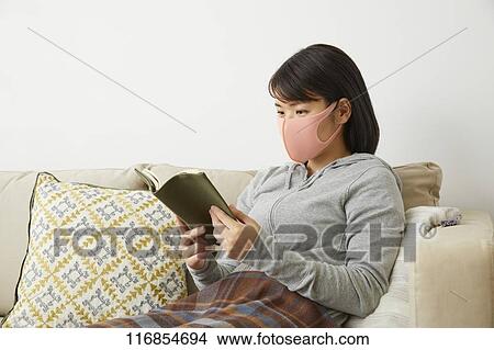 Picture - Sick Japanese woman wearing mask. Fotosearch