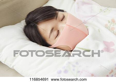 Sick Japanese woman wearing mask View Large Photo Image Stock Image - Sick Japanese woman wearing mask. Fotosearch