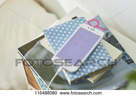 Stock Image - Smartphone in a bedroom. Fotosearch