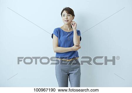 Stock Image - Studio portrait of attractive young Japanese woman. Fotosearch