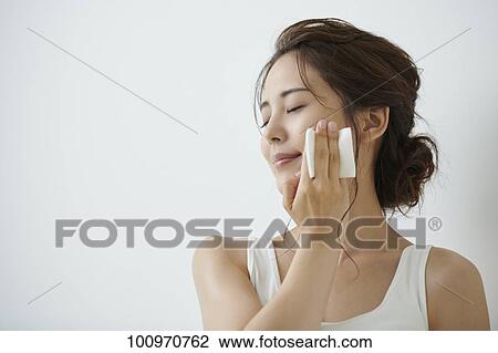 Stock Image - Studio portrait of attractive young Japanese woman. Fotosearch