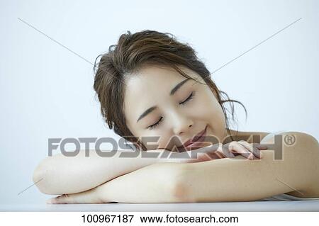 Stock Photo - Studio portrait of attractive young Japanese woman. Fotosearch