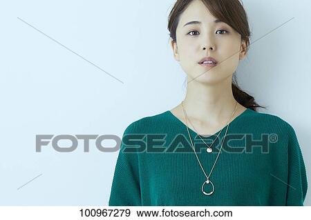 Stock Photo - Studio portrait of attractive young Japanese woman. Fotosearch
