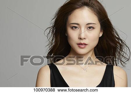 Stock Photo - Studio portrait of attractive young Japanese woman. Fotosearch