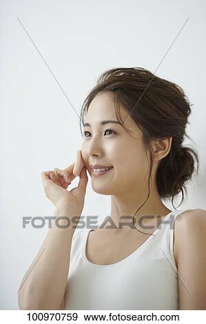 Stock Photo - Studio portrait of attractive young Japanese woman. Fotosearch