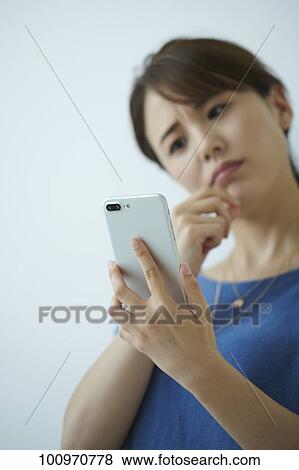 Stock Photo - Studio portrait of attractive young Japanese woman. Fotosearch