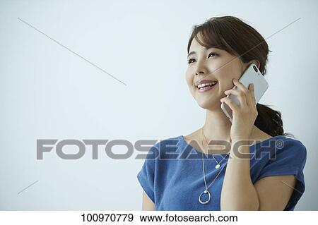 Stock Photo - Studio portrait of attractive young Japanese woman. Fotosearch