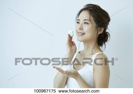 Stock Photography - Studio portrait of attractive young Japanese woman. Fotosearch