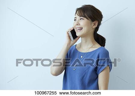 Stock Photography - Studio portrait of attractive young Japanese woman. Fotosearch