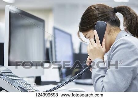 Tired Japanese businesswoman in the office View Large Photo Image Stock Photo - Tired Japanese businesswoman in the office. Fotosearch