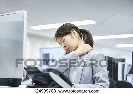 Tired Japanese businesswoman in the office View Large Photo Image Stock Photo - Tired Japanese businesswoman in the office. Fotosearch