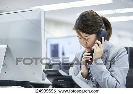 Tired Japanese businesswoman in the office View Large Photo Image Stock Photography - Tired Japanese businesswoman in the office. Fotosearch