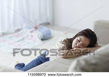Stock Image - Unhappy Japanese mother with newborn baby. Fotosearch