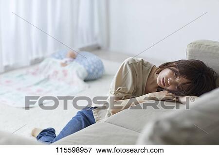 Stock Photo - Unhappy Japanese mother with newborn baby. Fotosearch