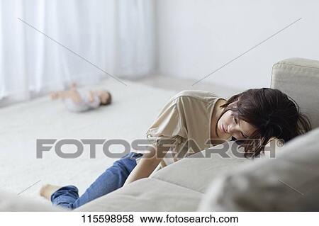 Stock Photo - Unhappy Japanese mother with newborn baby. Fotosearch