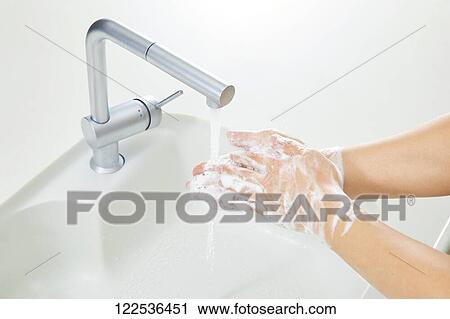 Stock Image - Woman washing hands. Fotosearch
