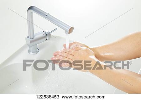 Stock Image - Woman washing hands. Fotosearch