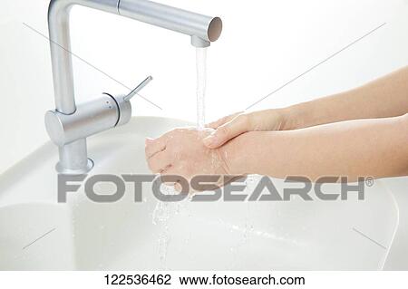 Stock Image - Woman washing hands. Fotosearch