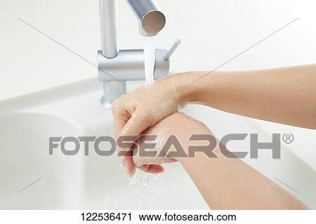 Stock Image - Woman washing hands. Fotosearch