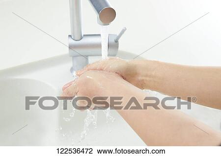 Stock Image - Woman washing hands. Fotosearch