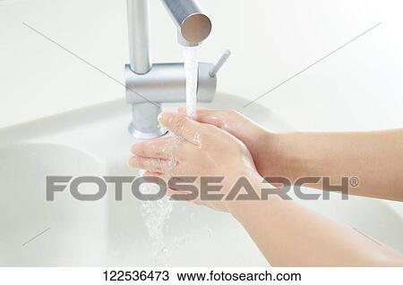 Stock Image - Woman washing hands. Fotosearch
