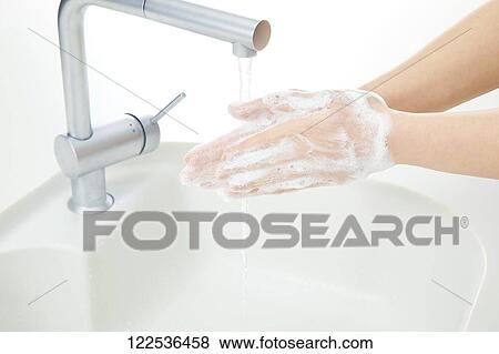 Stock Photo - Woman washing hands. Fotosearch