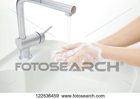 Stock Photo - Woman washing hands. Fotosearch