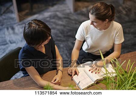 Young girlfriends at a cafe View Large Photo Image Picture - Young girlfriends at a cafe. Fotosearch