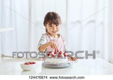 Young happy girl preparing a cake in the kitchen View Large Photo Image Picture - Young happy girl preparing a cake in the kitchen. Fotosearch