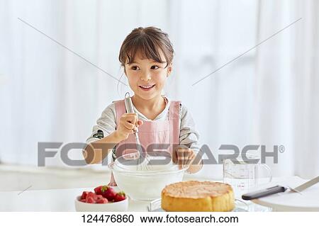 Young happy girl preparing a cake in the kitchen View Large Photo Image Stock Image - Young happy girl preparing a cake in the kitchen. Fotosearch