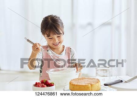 Young happy girl preparing a cake in the kitchen View Large Photo Image Stock Image - Young happy girl preparing a cake in the kitchen. Fotosearch