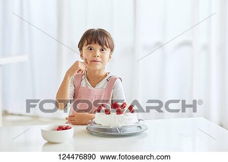Young happy girl preparing a cake in the kitchen View Large Photo Image Stock Image - Young happy girl preparing a cake in the kitchen. Fotosearch