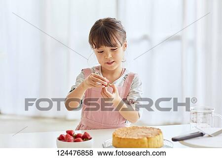 Young happy girl preparing a cake in the kitchen View Large Photo Image Stock Photo - Young happy girl preparing a cake in the kitchen. Fotosearch