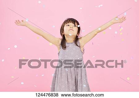 Stock Photo - Young happy girl studio portrait. Fotosearch