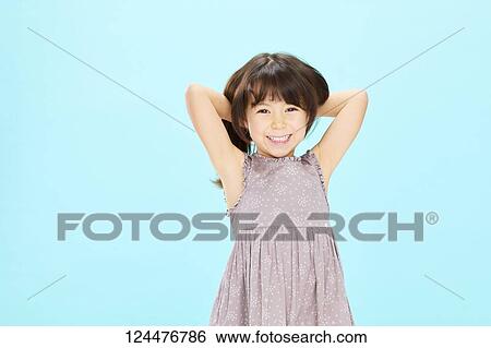 Stock Photograph - Young happy girl studio portrait. Fotosearch