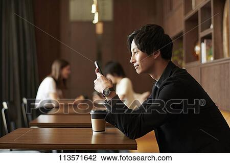 Young Japanese businessman at a cafe View Large Photo Image Stock Image - Young Japanese businessman at a cafe. Fotosearch