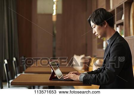 Young Japanese businessman at a cafe View Large Photo Image Stock Image - Young Japanese businessman at a cafe. Fotosearch