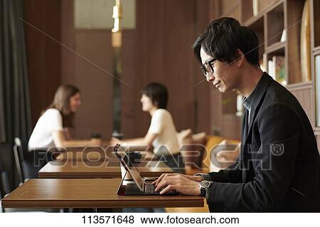 Young Japanese businessman at a cafe View Large Photo Image Stock Photo - Young Japanese businessman at a cafe. Fotosearch