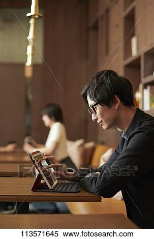 Young Japanese businessman at a cafe View Large Photo Image Stock Photography - Young Japanese businessman at a cafe. Fotosearch