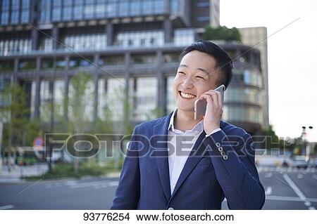 Picture - Young Japanese businessman downtown Tokyo. Fotosearch