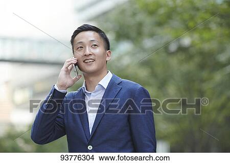 Picture - Young Japanese businessman downtown Tokyo. Fotosearch