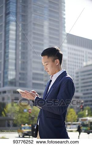Young Japanese businessman downtown Tokyo View Large Photo Image Stock Image - Young Japanese businessman downtown Tokyo. Fotosearch