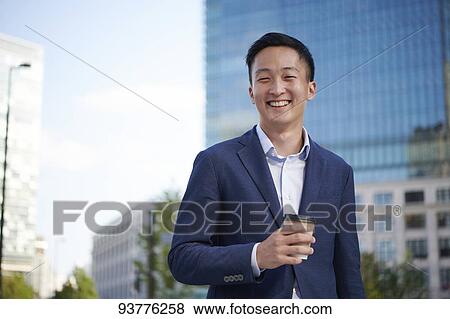 Young Japanese businessman downtown Tokyo View Large Photo Image Stock Photo - Young Japanese businessman downtown Tokyo. Fotosearch